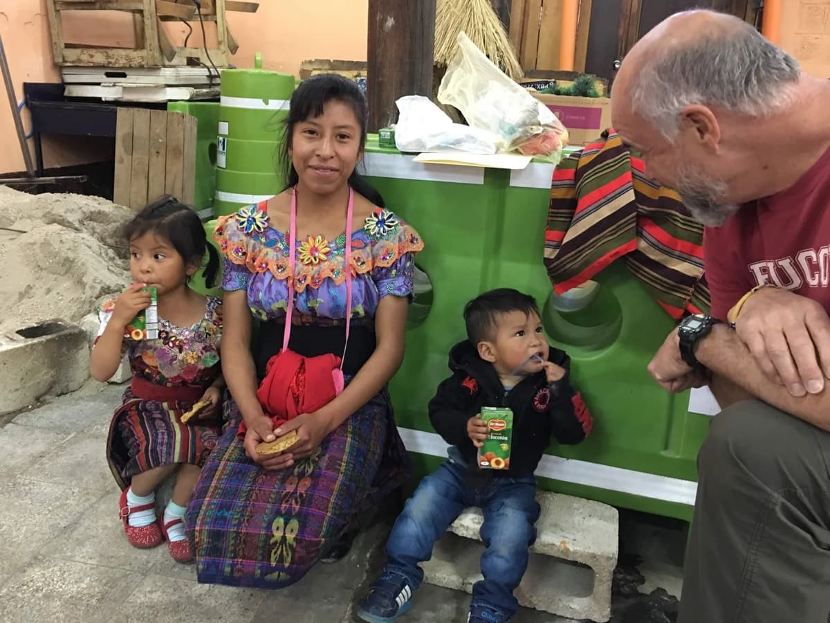 A physician greets a family waiting to be seen at the clinic
