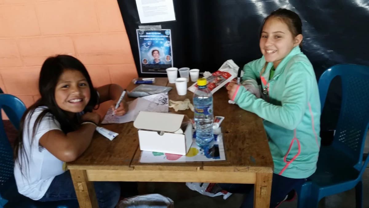 Children smiling at a table during a clinic day
