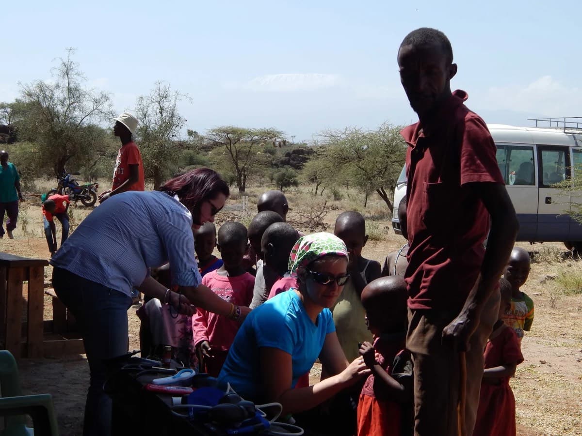 Volunteers working with community members at an outdoor clinic