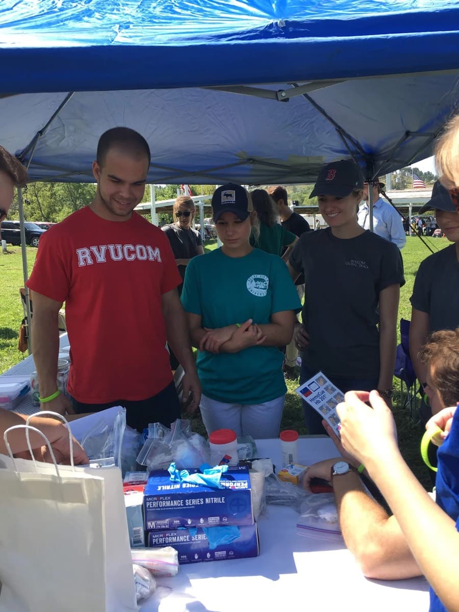 The team at their booth talking with community members