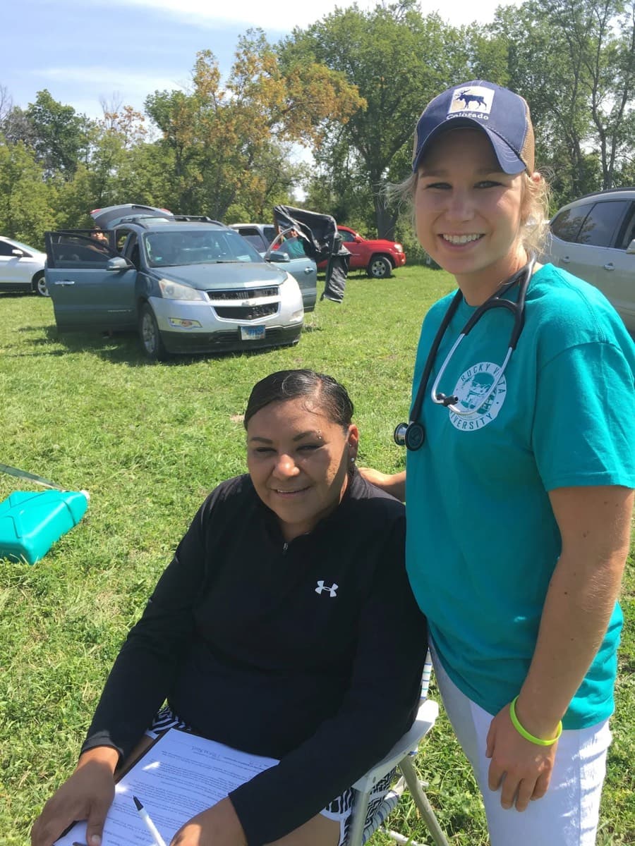 A volunteer with a community member at the health fair