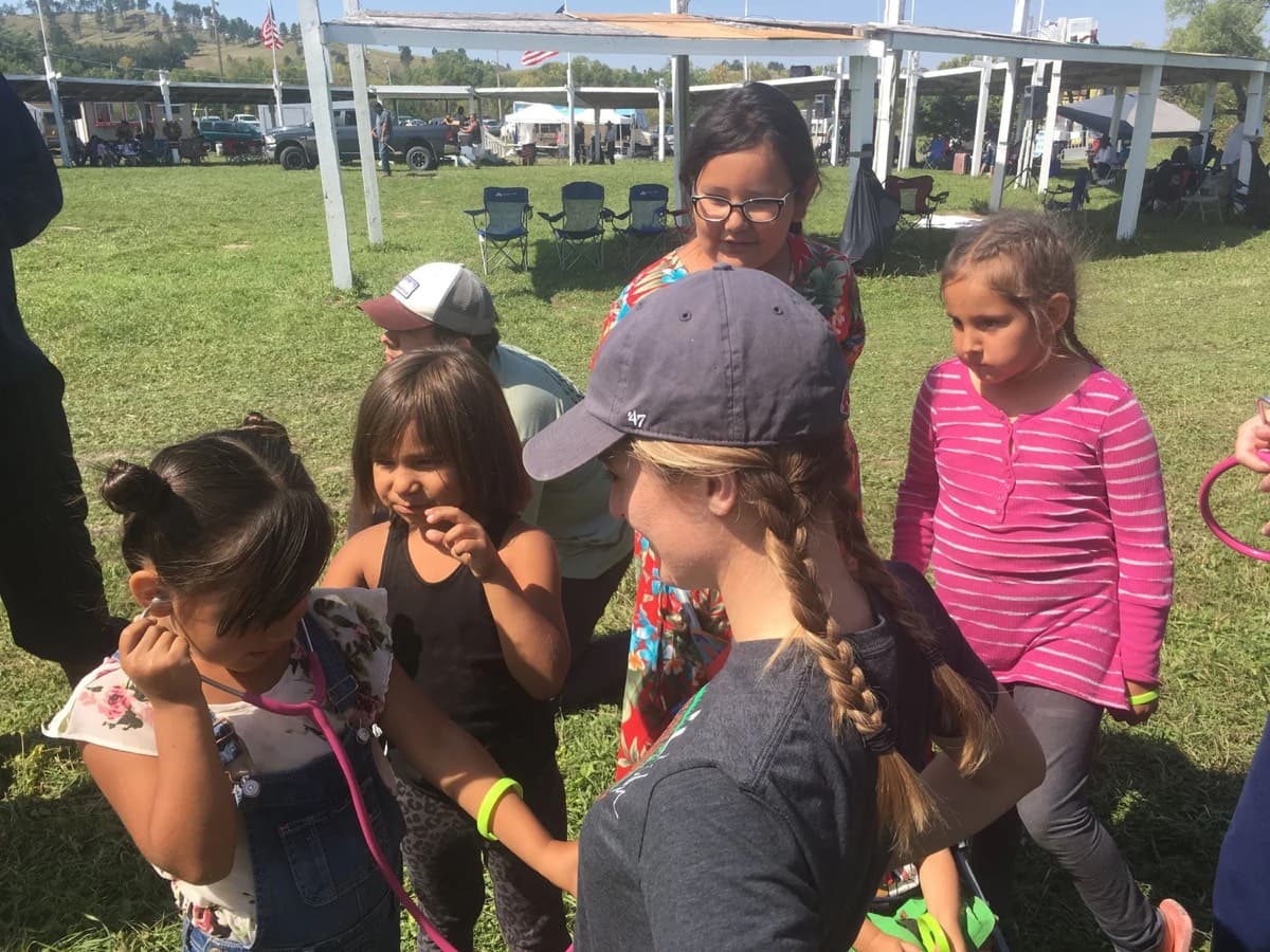 Volunteers with a group of children at the health fair